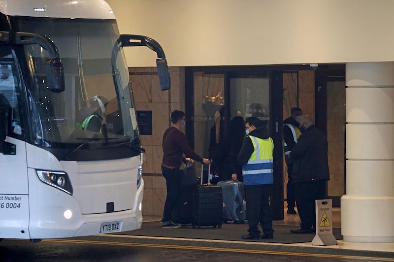 A coach delivers passengers to the Radisson Blu Edwardian Hotel, near Heathrow Airport, where they will remain during a 10 day quarantine period. AP Photo