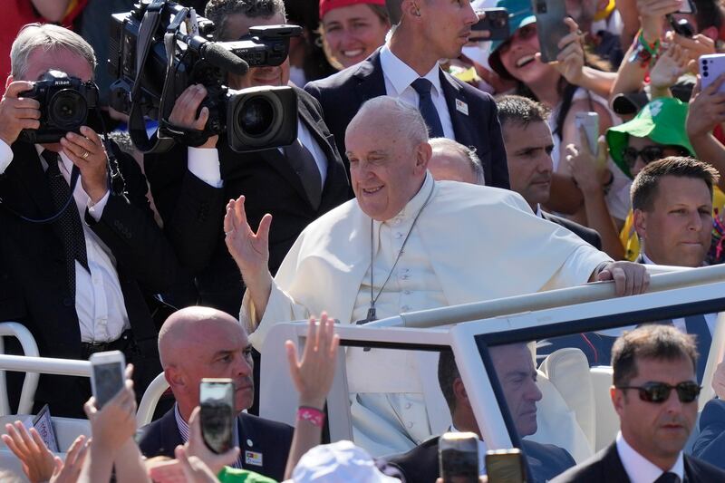 Pope Francis waves at a gathering of young people in Eduardo VII Park in Lisbon. AP