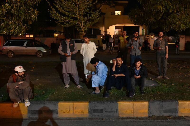 People gather outside a mall in Islamabad after the earthquake, which was felt in Pakistan, Afghanistan and parts of India.  AFP
