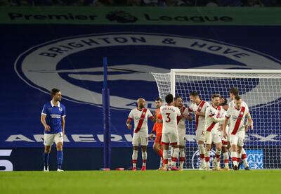 BRIGHTON, ENGLAND - DECEMBER 07: Danny Ings of Southampton(C) celebrates after scoring their sides second goal from the penalty spot with Ryan Bertrand of Southampton (4L) during the Premier League match between Brighton & Hove Albion and Southampton at American Express Community Stadium on December 07, 2020 in Brighton, England. A limited number of fans (2000) are welcomed back to stadiums to watch elite football across England. This was following easing of restrictions on spectators in tiers one and two areas only. (Photo by Naomi Baker/Getty Images)