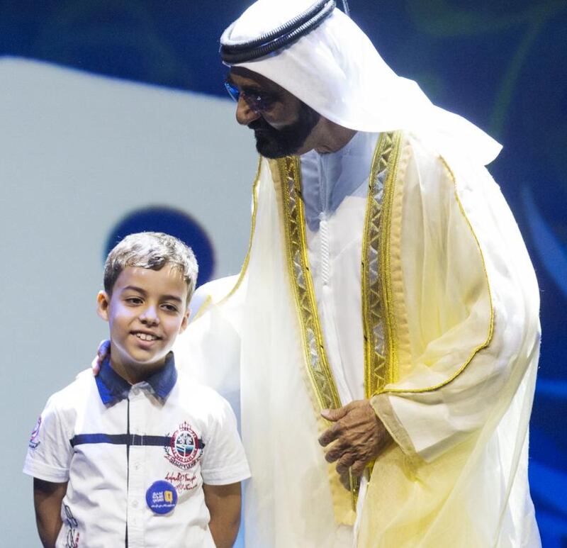 Sheikh Mohammed bin Rashid, Vice President and Ruler of Dubai, congratulates Mohammed Farah of Algeria after he won the Arab Reading Challenge last October. Christopher Pike / The National