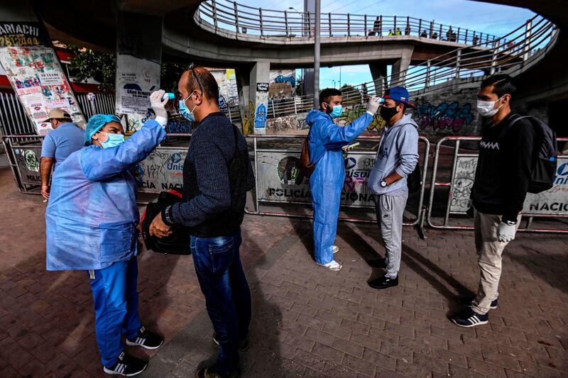 People get their temperature checked by health workers as a preventive measure against the spread of the new coronavirus in Bogota, Colombia. Latin America had more than 20,000 cases of Covid-19 as of April 1, 2020 - double the figure from five days earlier, according to an AFP tally. AFP
