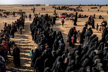 Civilians evacuated from ISIS's embattled holdout of Baghouz in Syria wait at a screening area held by the US-backed Kurdish-led Syrian Democratic Forces. AFP