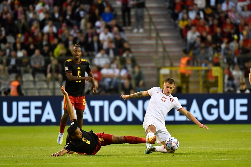 Poland's Damian Szymanski, right, and Belgium's Youri Tielemans fight for the ball. AP