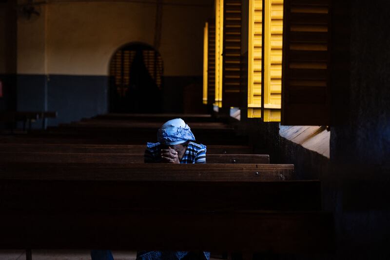 A worshipper prays at a cathedral in Ouagadougou, the capital city of Burkina Faso. AFP