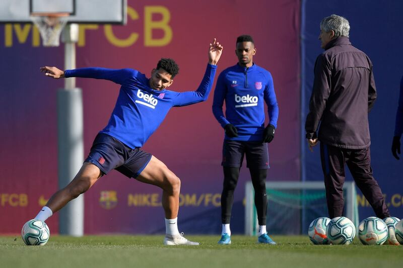 Barcelona's Uruguayan defender Roland Araujo, left,  takes part in training next to manager Quique Setien. AFP