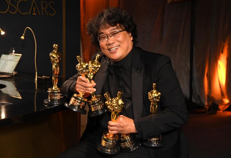 Bong Joon-ho holds the Oscars for best original screenplay, best international feature film, best directing, and best picture for "Parasite" at the Governors Ball after the Oscars on Sunday, February 9, 2020, at the Dolby Theatre in Los Angeles. AP