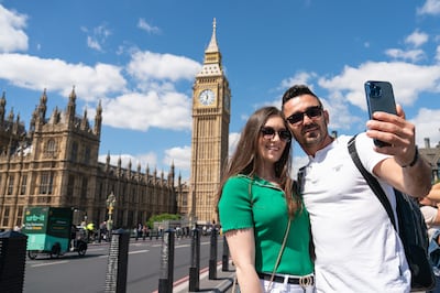 Tourists pose for a selfie in front of Elizabeth Tower and the Houses of Parliament. PA
