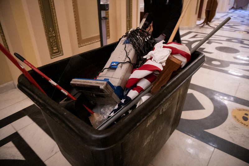 A worker pushes a trash bin at the US Capitol building in Washington. Bloomberg