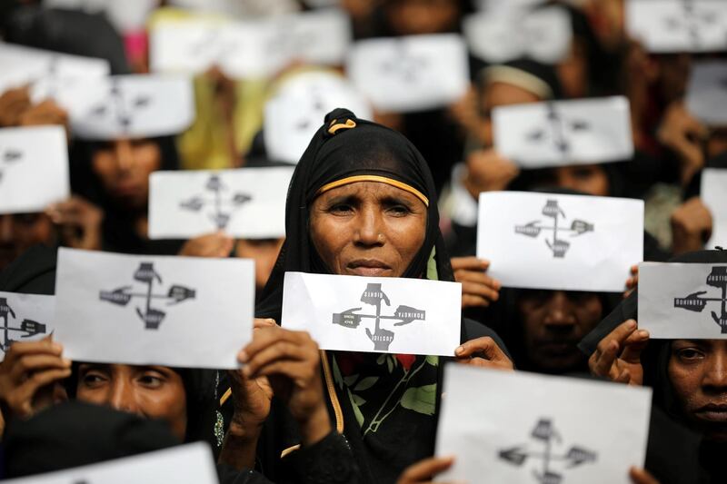 Rohingya refugee women hold placards as they take part in a protest at the Kutupalong refugee camp to mark the one-year anniversary of their exodus in Cox's Bazar, Bangladesh. Reuters