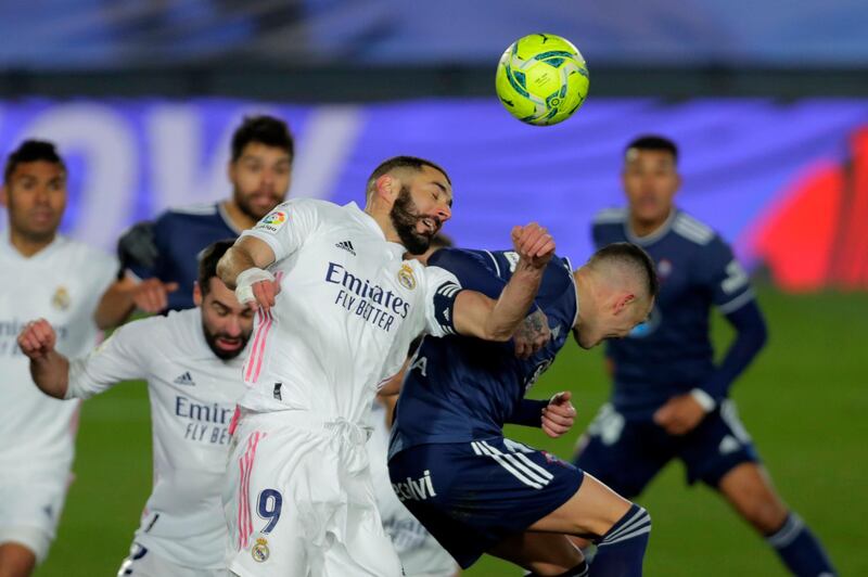 Real Madrid attacker Karim Benzema, left, wins a header over Celta Vigo's Iago Aspas. AP