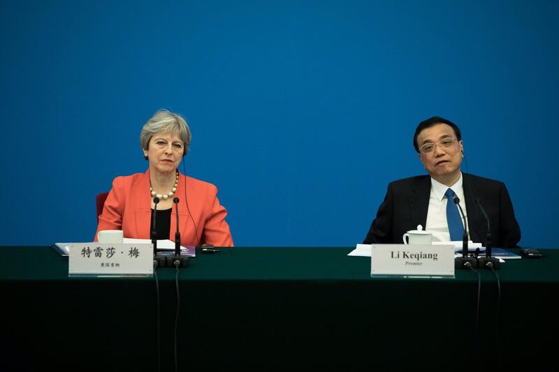 epa06487992 British Prime Minister Theresa May (L) and Li Keqiang, China's premier, listen to speakers during the CEO council at the Great Hall of the People in Beijing, China, 31 January 2018. May is leading the largest business delegation her government has ever taken overseas as she seeks to put her Brexit troubles aside and make progress on boosting the UK's trade.  EPA/CHRIS RATCLIFFE / POOL