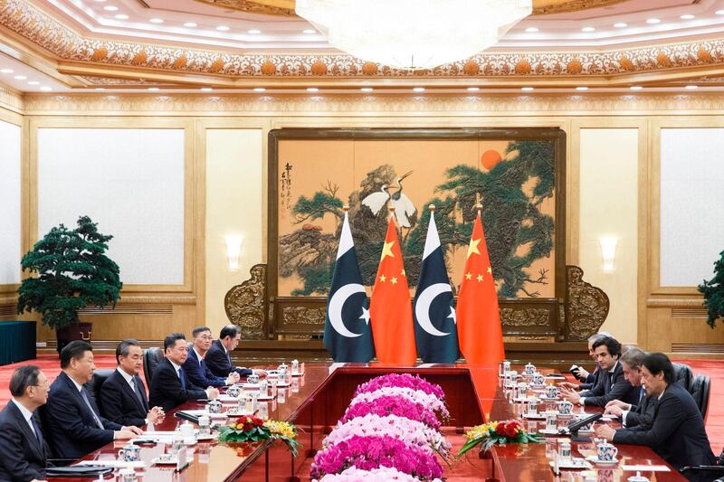 China's President Xi Jinping (2nd L) listens to Pakistan's Prime Minister Imran Khan (R) during their meeting at the Great Hall of the People in Beijing.  AFP