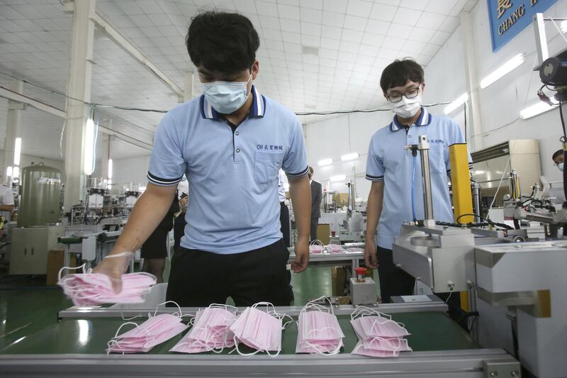 Workers arrange face masks at a factory where US Health and Human Services Secretary Alex Azar visited during an inspection tour in New Taipei City, Taiwan. AP Photo