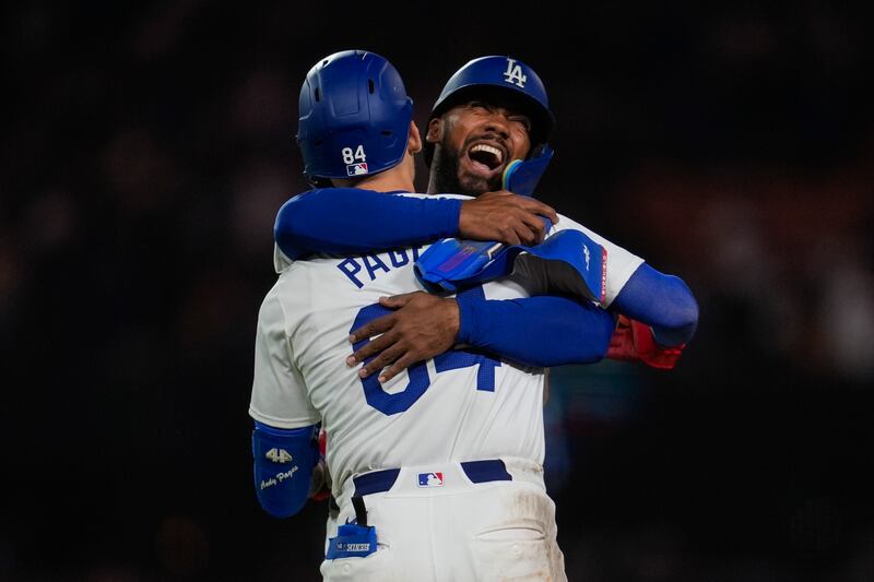 Los Angeles Dodgers' Andy Pages (number 84) celebrates with Teoscar Hernández after a single during the 11th inning of their baseball game against the Atlanta Braves in Los Angeles. The Dodgers won 4-3. AP 
