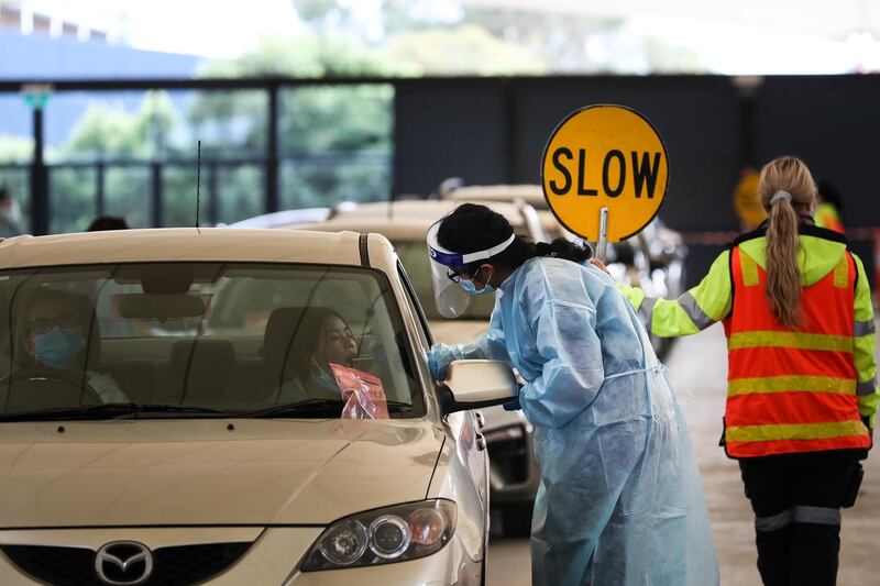 A medical worker conducts a Covid-19 test at a drive-through testing facility at the Melbourne Showgrounds, in Melbourne, Australia. Getty Images
