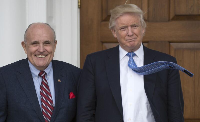 (FILES) In this file photo taken on November 20, 2016 former President-elect Donald Trump meets with former New York City Mayor Rudy Giuliani at the clubhouse of the Trump National Golf Club in Bedminster, New Jersey.
Rudy Giuliani, the former New York mayor, 9/11 hero and prosecutor who jailed the mafia, was thrust into a gathering storm on May 4, 2018, accused of exacerbating Donald Trump's already fraught legal woes. Appointed to the president's personal legal team on April 19, the 73-year-old maverick dropped a bombshell when he went on Fox News to disclose that Trump had paid back hush-money given in October 2016 to porn star Stormy Daniels.
 / AFP PHOTO / Don EMMERT