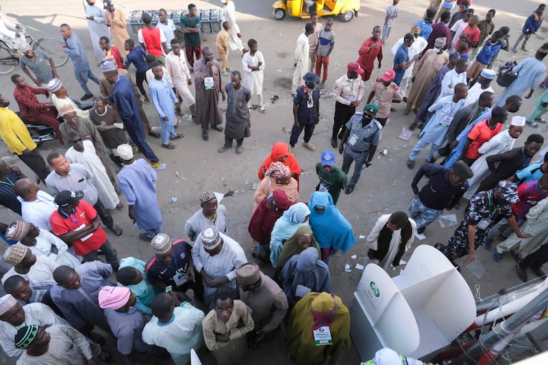 Voters queue outside a polling station in Kano. AFP