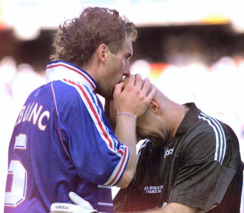 French defender Laurent Blanc (L) kisses French goalkeeper Fabien Barthez after scoring the first golden goal in World Cup history to give France a 1-0 win 28 June at the Felix Bollaert stadium in Lens, northern France, after the 1998 Soccer World Cup second round match between France and Paraguay.   (ELECTRONIC IMAGE)    AFP PHOTO (Photo by PHILIPPE HUGUEN / AFP)