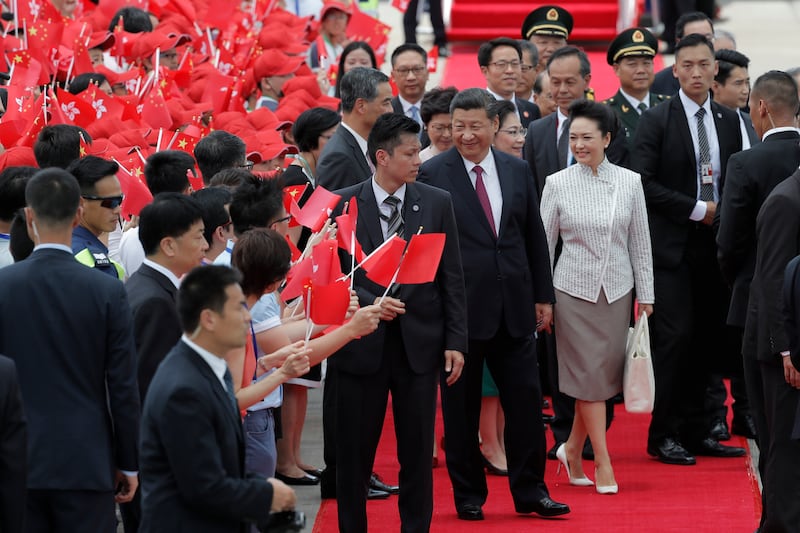 Chinese President Xi Jinping, centre right, and wife Peng Liyuan greeted on their arrival in Hong Kong by supporters waving red Hong Kong and Chinese flags on Thursday, June 29, 2017.The visit is to mark 20 years since China took control in the former British colony.Kin Cheun / Associated Press