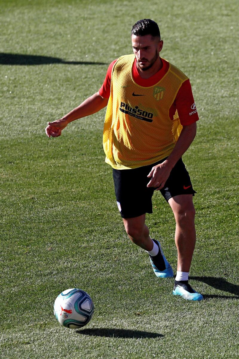 Koke looks to make a pass during training.