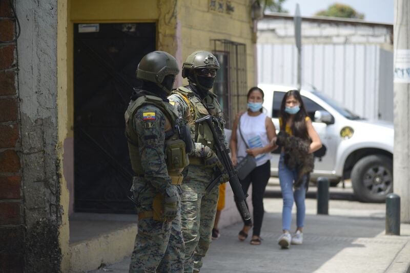 Members of the Marines stand guard in a street of southern Guayaquil, Ecuador on October 19, 2021. AFP