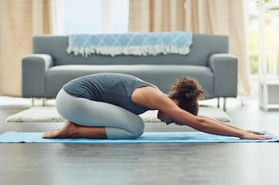 Shot of an attractive young woman practicing yoga at home