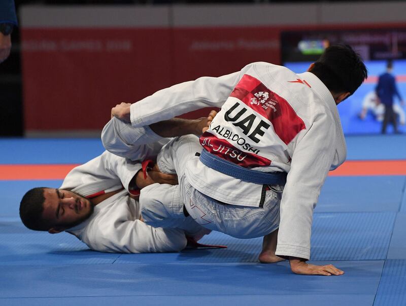 Khalid Al Blooshi (R) of United Arab Emirates grabbles against compatriot Hanad Nawad in the Jujitsu Newaza men's under 56Kg finals during the 2018 Asian Games in Jakarta. AFP