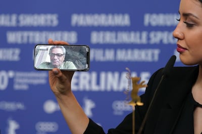 BERLIN, GERMANY - FEBRUARY 29:  Baran Rasoulof phones Iranian director Mohammad Rasoulof, winner of the Golden Bear for Best Film for the film "There Is No Evil" at the award winners press conference during the 70th Berlinale International Film Festival Berlin at Grand Hyatt Hotel on February 29, 2020 in Berlin, Germany. (Photo by Thomas Niedermueller/Getty Images)