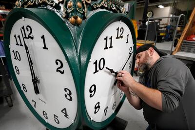 Clock technician Dan LaMoore adjusts the hands on a large outdoor clock under construction in US city of Woonsocket, Rhode Island. AP