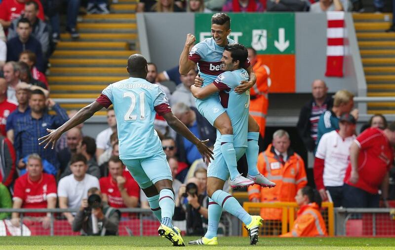 Manuel Lanzini celebrates with teammates after scoring the first goal for West Ham against Liverpool on Saturday. Eddie Keogh / Reuters