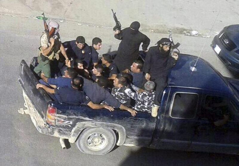 File picture taken on August 2, 2014 of gunmen driving away with about a dozen men in Arsal, a Sunni Muslim town near the Syrian border in eastern Lebanon. The ISIL threat first came to Lebanon in August, two months after the group’s summer blitz in which it seized large swaths of territory in Iraq and Syria. AP Photo