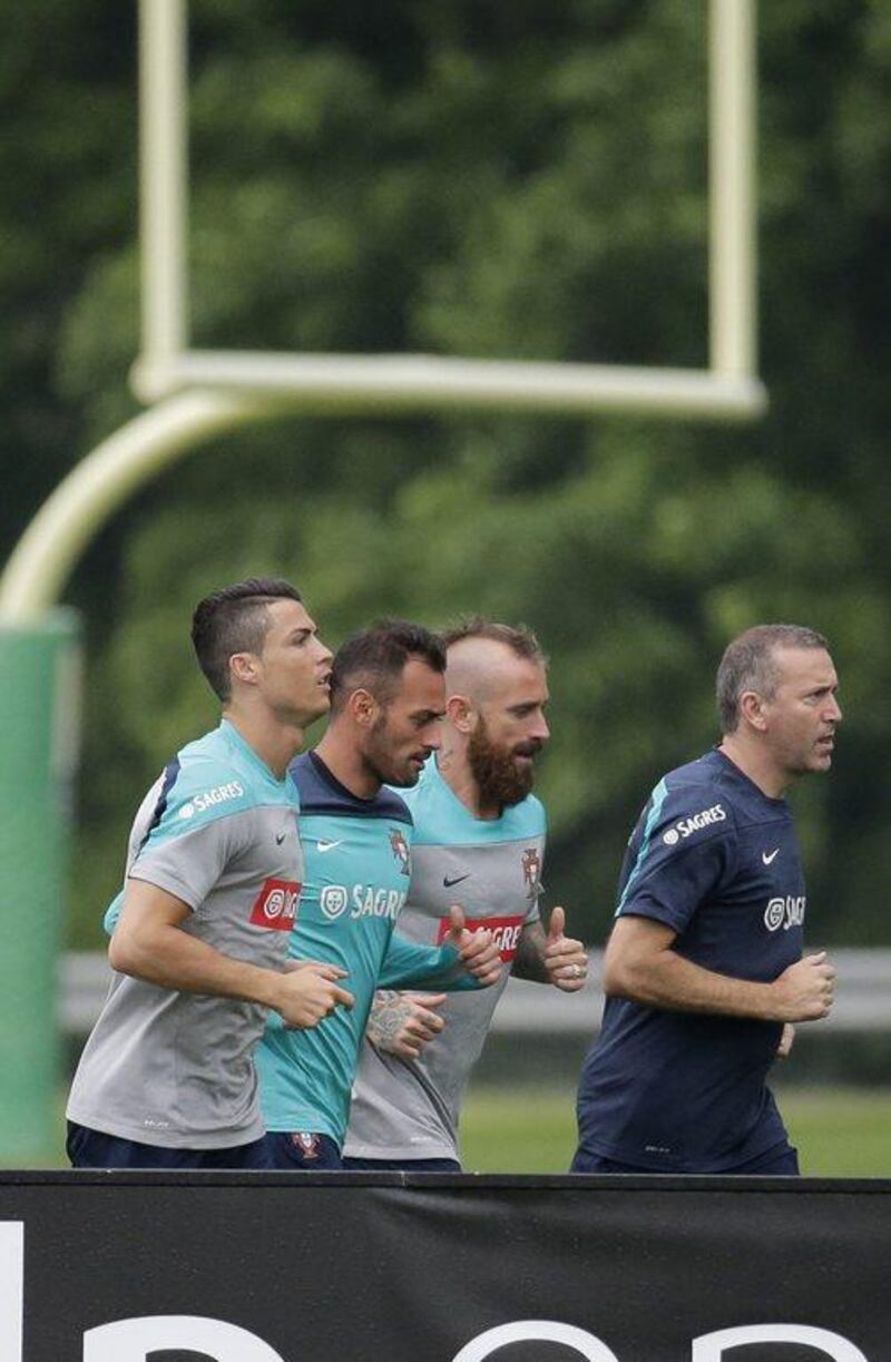 Cristiano Ronaldo shown running with Portugal teammates Hugo Almeida, second left, Raul Meireles, third left and a coach as they get ready for the 2014 World Cup. Ray Stubblebine / Reuters / June 3, 2014