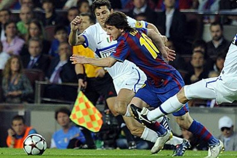 Barcelona's Lionel Messi tries to escape the attention of the Inter Milan captain. Javier Zanetti.