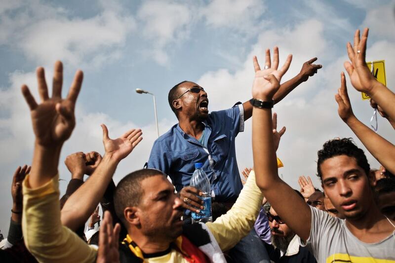 Muslim Brotherhood supporters shout slogans outside the Police Academy where Mohammed Morsi's trial was held on November 4. AFP