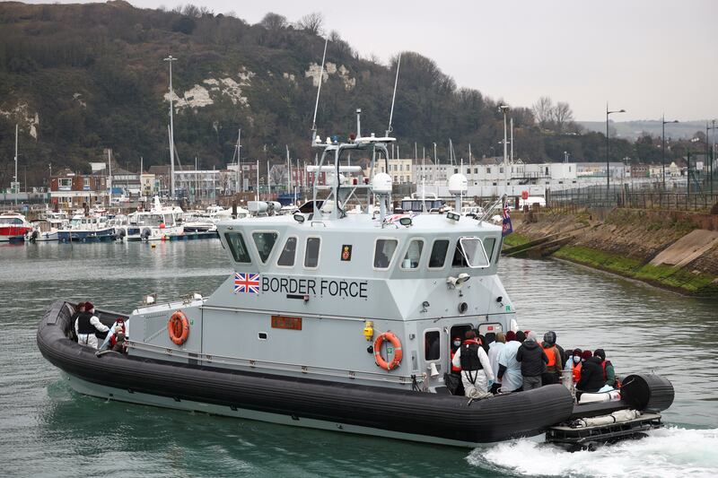 Migrants arrive into the Port of Dover onboard a Border Force vessel after being rescued while crossing the English Channel. Reuters.