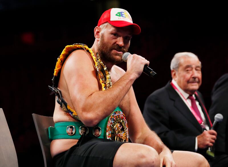 Tyson Fury during a press conference after winning the fight against Deontay Wilder, as promoter Bob Arum looks on. Reuters