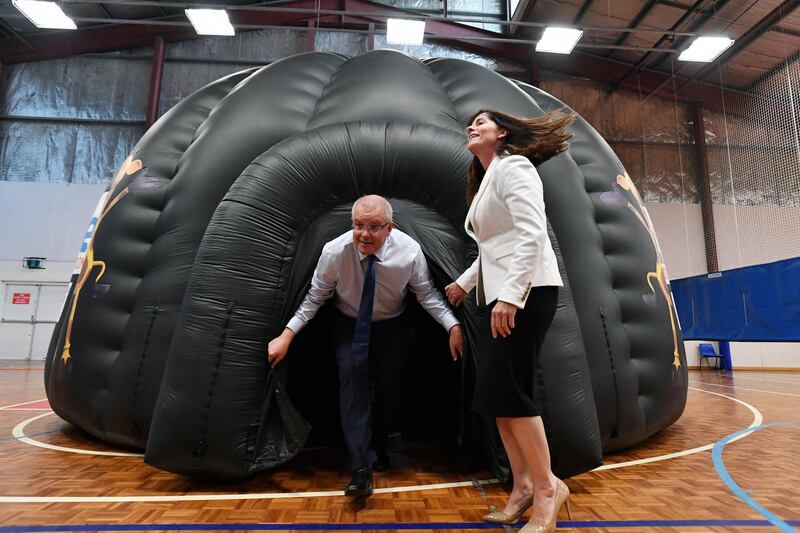 Australian Prime Minister Scott Morrison and Liberal member for Robertson Lucy Wicks emerge from a Life Education bubble during a cyber bullying announcement at Bateau Bay PCYC Club on the Cental Coast,  Australia. EPA