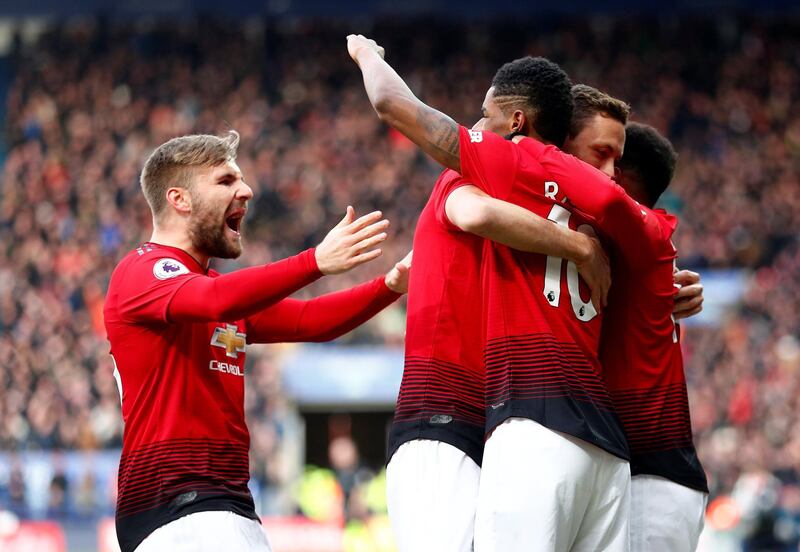 Rashford celebrates scoring United's goal with Shaw and teammates. Reuters