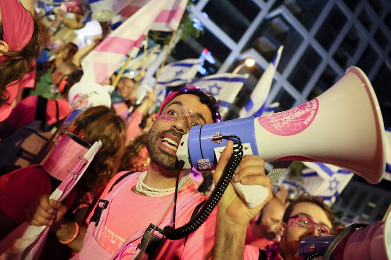 A demonstrator with a megaphone leads chants at the Tel Aviv protest as the country begins celebrations for its 75th anniversary, on April 25. AFP