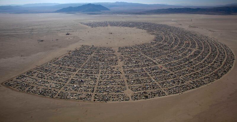 The Burning Man 2011 "Rites of Passage" arts and music festival is seen in this aerial view taken in the Black Rock desert of Nevada September 3, 2011. More than 50,000 people from all over the world have gathered at the sold out festival which is celebrating its 25th year.      REUTERS/Jim Urquhart (UNITED STATES - Tags: SOCIETY) FOR EDITORIAL USE ONLY. NOT FOR SALE FOR MARKETING OR ADVERTISING CAMPAIGNS. NO THIRD PARTY SALES. NOT FOR USE BY REUTERS THIRD PARTY DISTRIBUTORS *** Local Caption ***  SLC19_BURNING-MAN-_0903_11.JPG