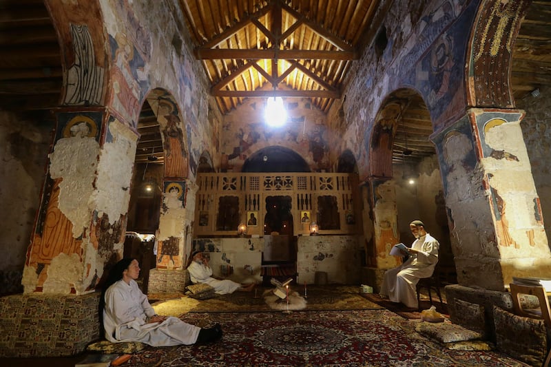 Monks and nuns sit in prayer and contemplation at Deir Mar Moussa Al Habashi.