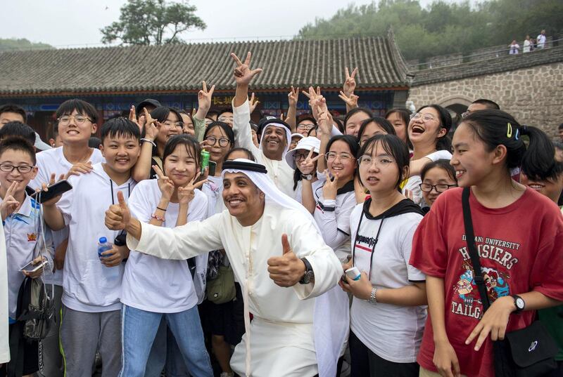 One of the men poses with Chinese onlookers. Courtesy WAM