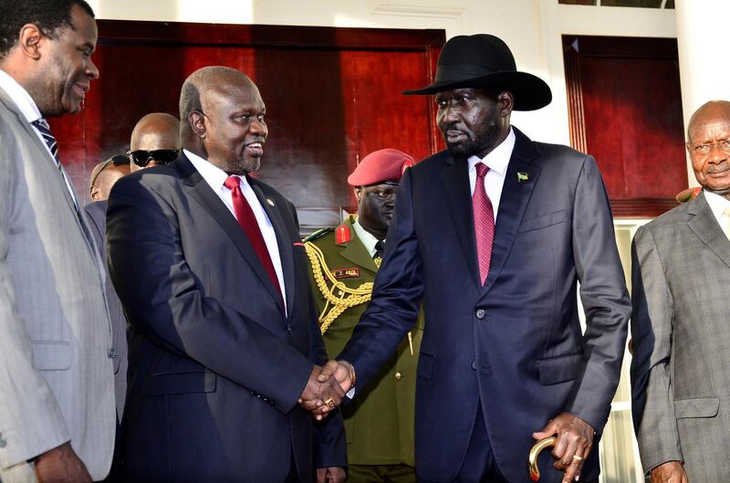 Leader of the Sudan People's Liberation Movement In Opposition (SPLM-IO) Riek Machar shakes hands with South Sudan's President Salva Kiir after a tripartite summit on the revitalised agreement on resolutions of the conflict in South Sudan, at the State House in Entebbe, Uganda, November 7, 2019. REUTERS/Stringer NO RESALES. NO ARCHIVES