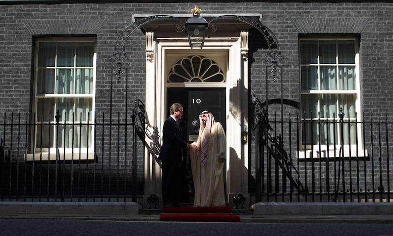 Britain's Prime Minister David Cameron (L) greets Emirati President Sheikh Khalifa bin Zayed al-Nahayan (R) at 10 Downing Street in Central London on May 1, 2013. The UAE president was to face questions from Prime Minister David Cameron over allegations that three British men jailed in Dubai were tortured. Sheikh Khalifa bin Zayed al-Nahyan, head of state of the United Arab Emirates, will hold talks with Cameron at his Downing Street office on the second day of a two-day state visit to Britain.  AFP PHOTO / ANDREW COWIE
 *** Local Caption ***  027285-01-08.jpg