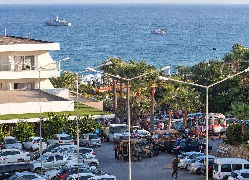 Turkish military vehicles are parked on the grounds of the Acapulco hotel in Kyrenia (Girne) in the self-proclaimed Turkish Republic of Northern Cyprus (TRNC) north of the divided Cypriot capital Nicosia, after the building was damaged when a military depot exploded nearby, on September 12, 2019. Multiple explosions at a Turkish military base in northern Cyprus damaged a hotel in a neighbouring holiday resort early Thursday, prompting the evacuation of terrified tourists, officials said. / AFP / Birol BEBEK
