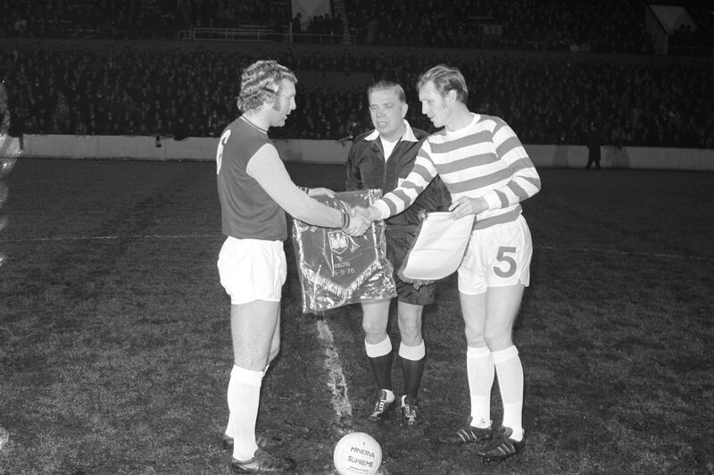 English professional footballer and captain of West Ham, Bobby Moore (1941-1993) pictured on left exchanging pennants with Scottish footballer and captain of Celtic, Billy McNeill prior to play in Bobby Moore's testimonial match at the Boleyn Ground in Upton Park, London on 16th November 1970. The match would end in a 3-3 draw. (Photo by Daily Express/Hulton Archive/Getty Images)