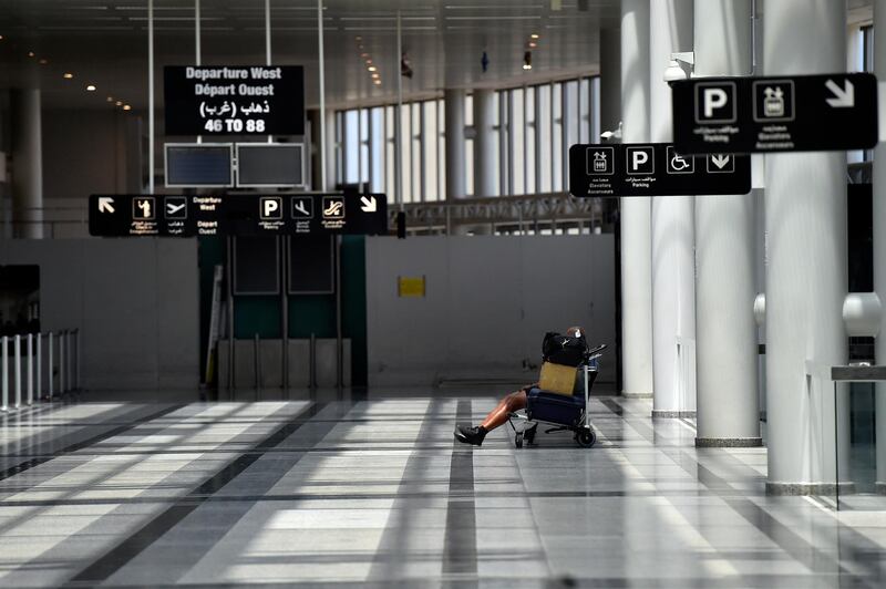 A passenger waits in the departure hall of the Rafik Hariri international airport during its re-opening in Beirut. EPA
