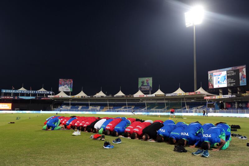 Afghanistan and Pakistan’s T20 teams pray together on the second day of Ramadan before play at Sharjah Cricket Stadium. Chris Whiteoak / The National