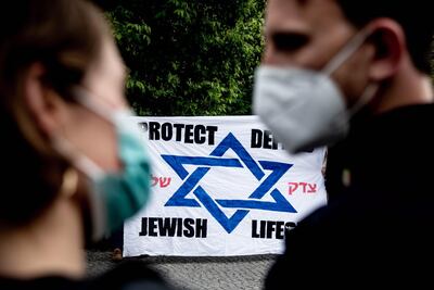 epa09205160 Participants of a vigil against anti-Semitism gather in front of the Synagogue in Kreuzberg, Berlin, Germany, 16 May 2021.  An initiative against anti-Semitism in Berlin has called for the vigil to show solidarity with the Jewish community. On 14 May, German Chancellor Angela Merkel condemned antisemitic incidents against synagogues in Germany motivated by the current violence in Israel and Gaza.  EPA/FILIP SINGER